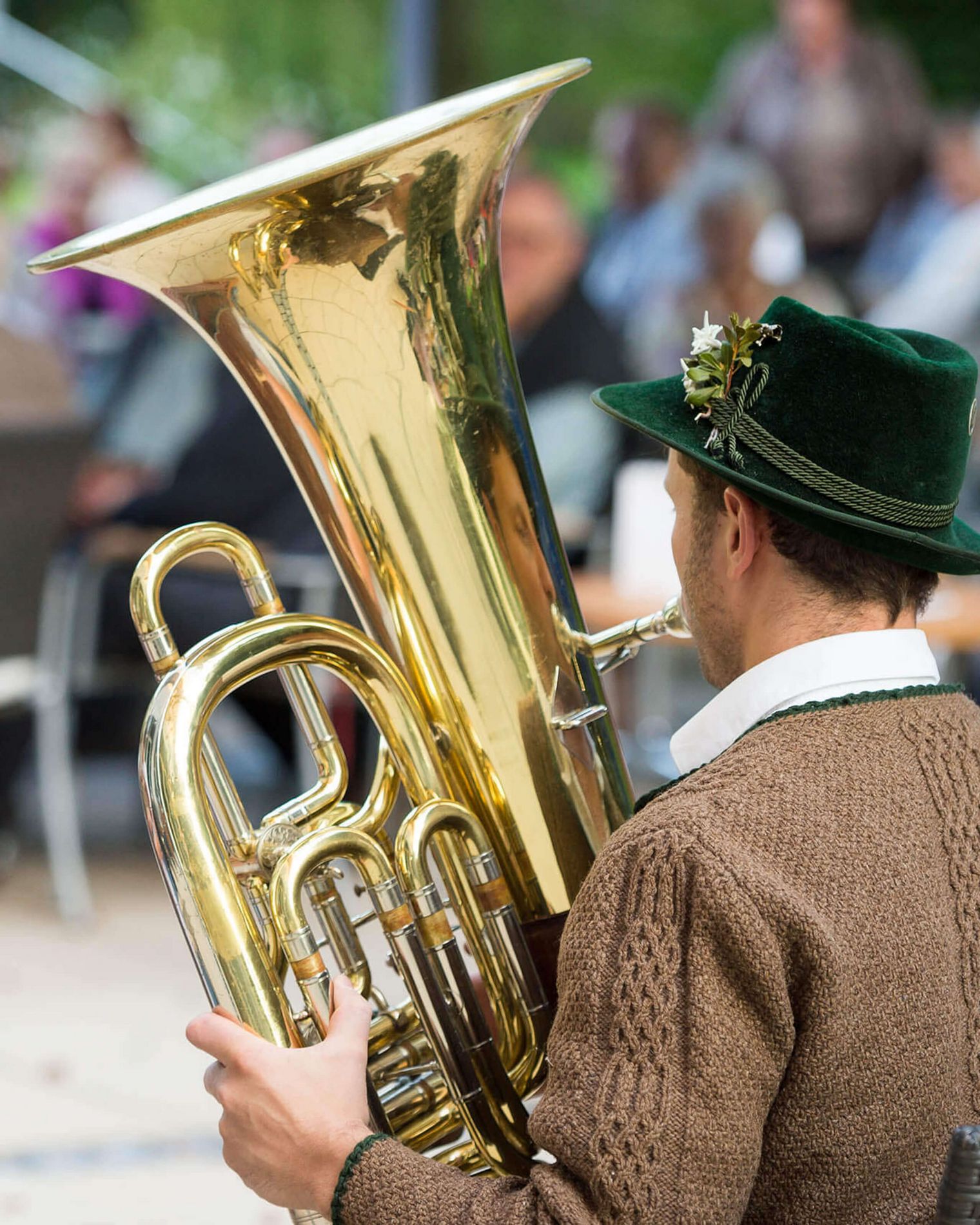Volksmusikant in Tracht mit Tuba spielt im Brunnenhof Bad Aibling